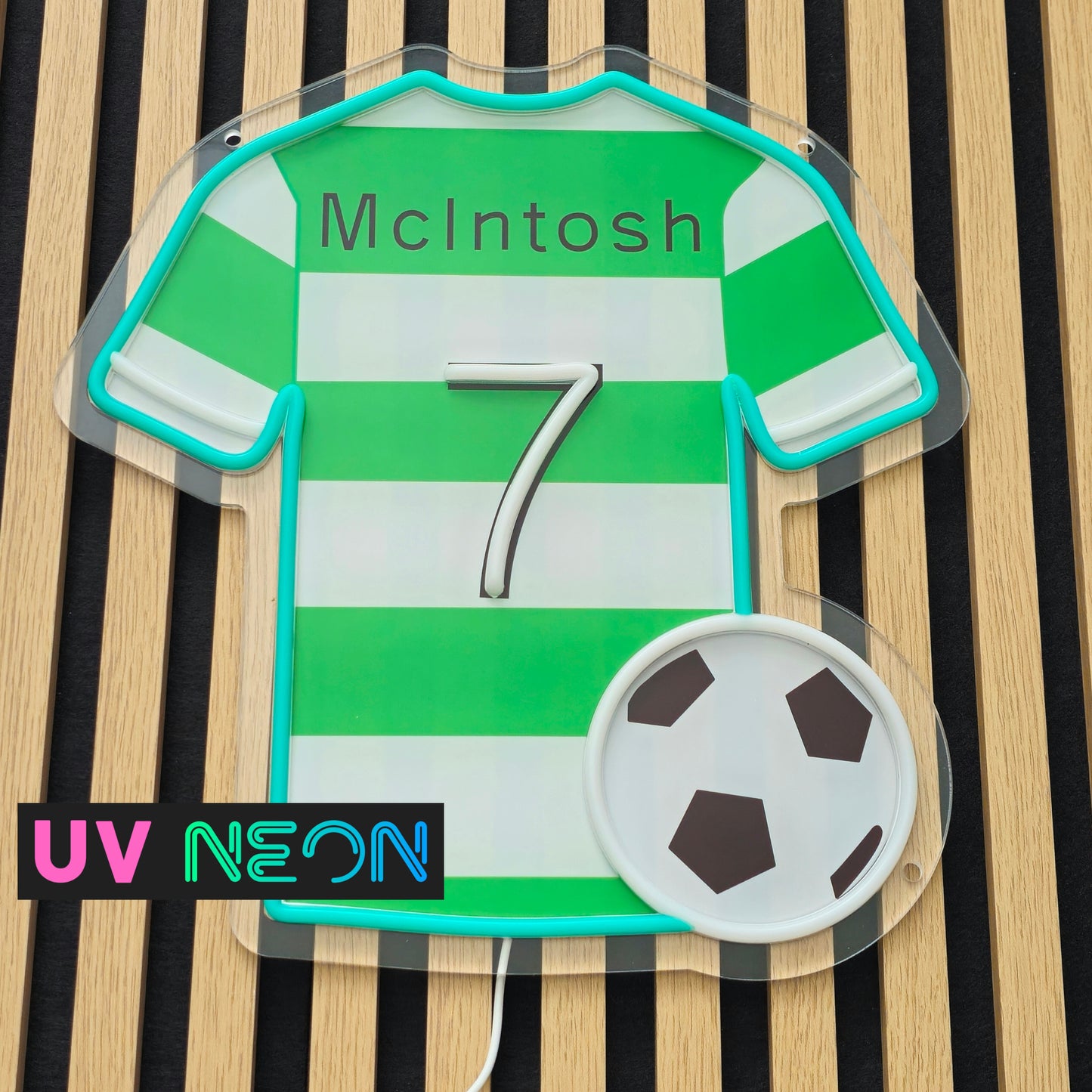 Unlit custom Celtic-style LED neon sign shaped like a football jersey on clear acrylic backing