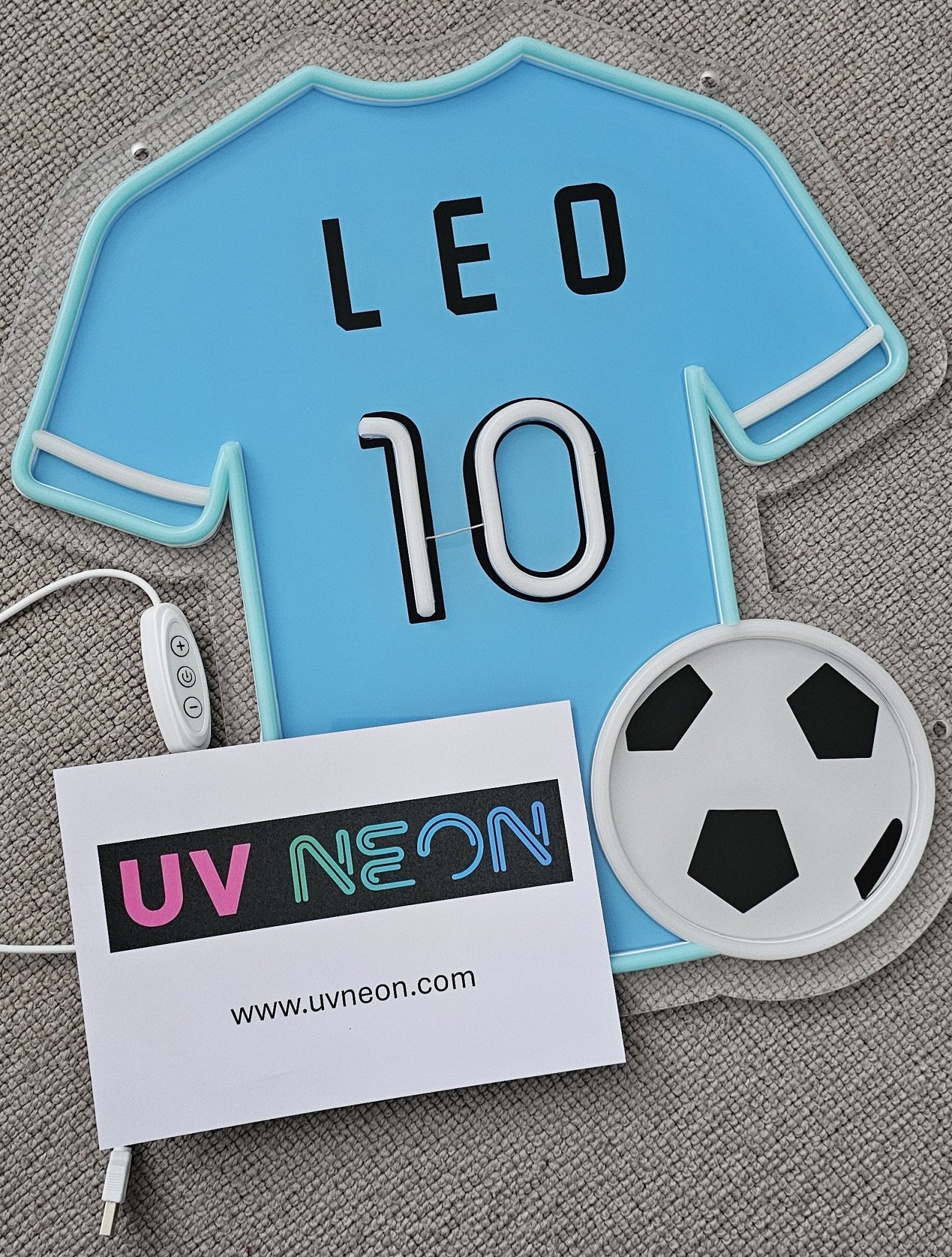 Manchester City football shirt-shaped neon sign in sky blue with lights turned off on acrylic mount