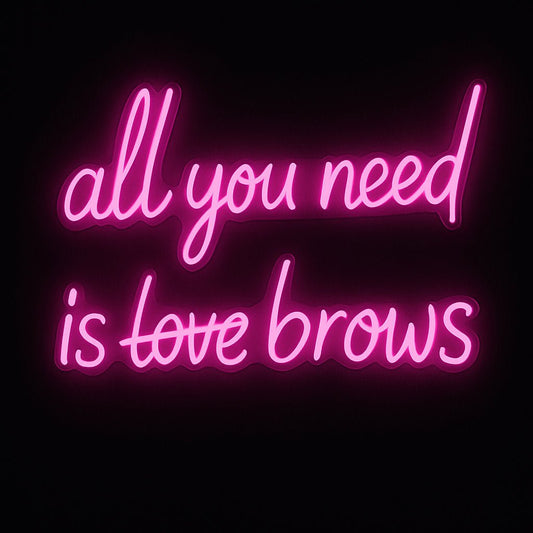 All You Need Is Brows neon sign in pink LED flex with "love" struck through, on acrylic backing – perfect for beauty salons and brow bar décor