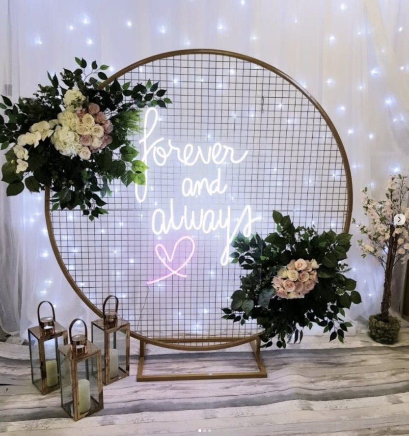 Forever and Always neon sign on wedding mesh backdrop with florals and candles