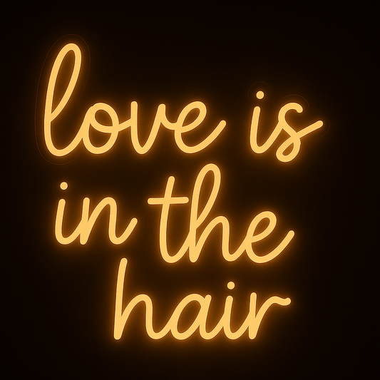 Love Is In The Hair neon sign in warm white LED on acrylic backing, perfect for hair salon wall décor and stylist branding.