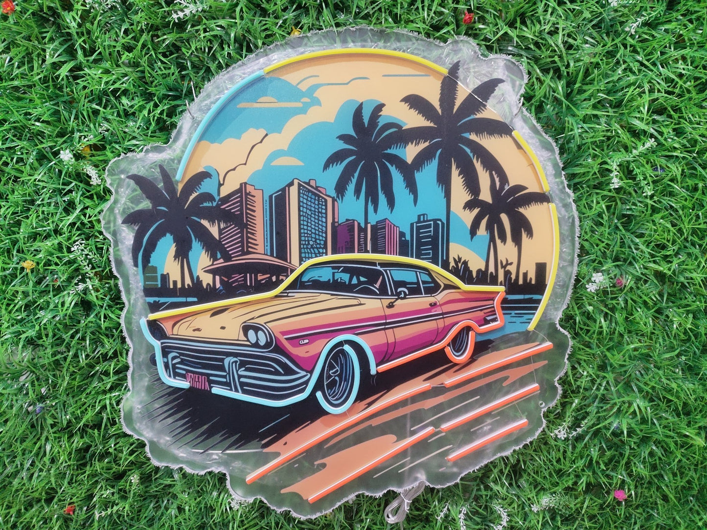 Retro car Miami sunset neon sign switched off showing UV printed 80s synthwave design with palm trees and cityscape on acrylic