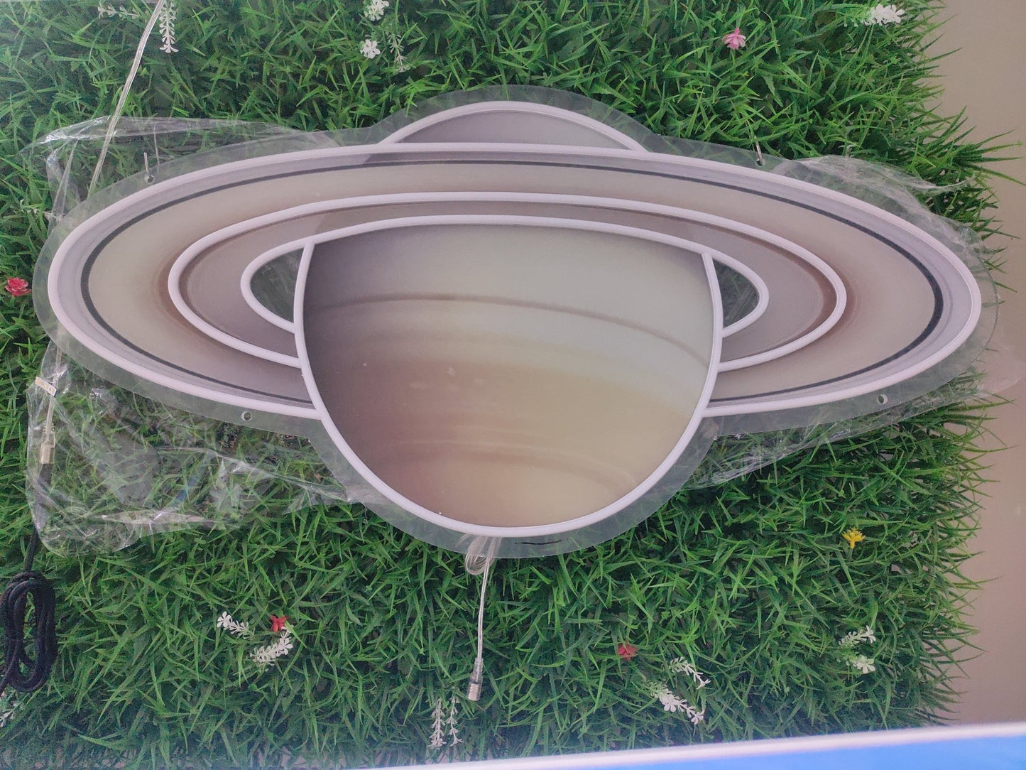 Saturn UV printed neon sign switched off showing detailed planet design on clear acrylic panel