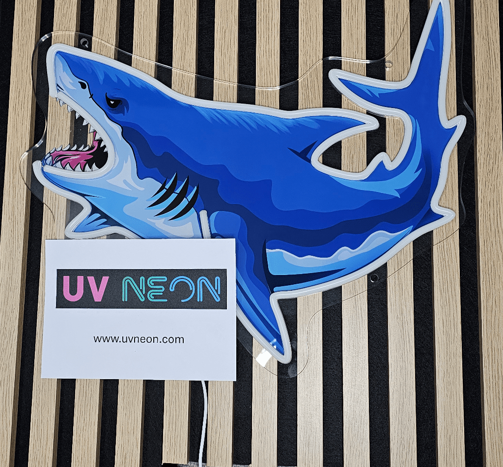 Shark UV neon sign switched off – acrylic-backed cartoon shark design in blue tones, shown unlit on striped wood background