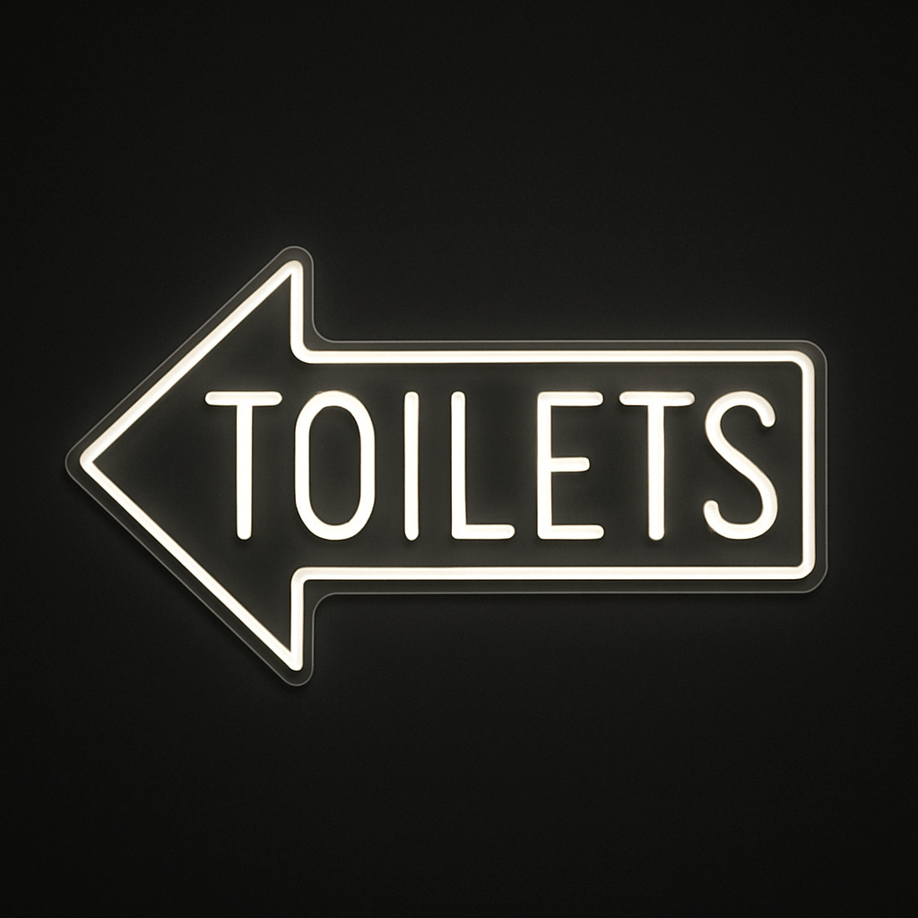 TOILETS neon sign with left-pointing arrow in LED flex and acrylic backing on black background – ideal for cafés, restaurants, bars, and retail spaces