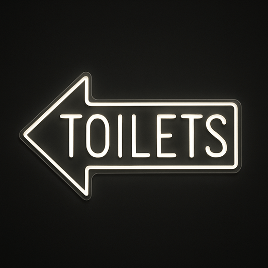 TOILETS neon sign with left-pointing arrow in LED flex and acrylic backing on black background – ideal for cafés, restaurants, bars, and retail spaces