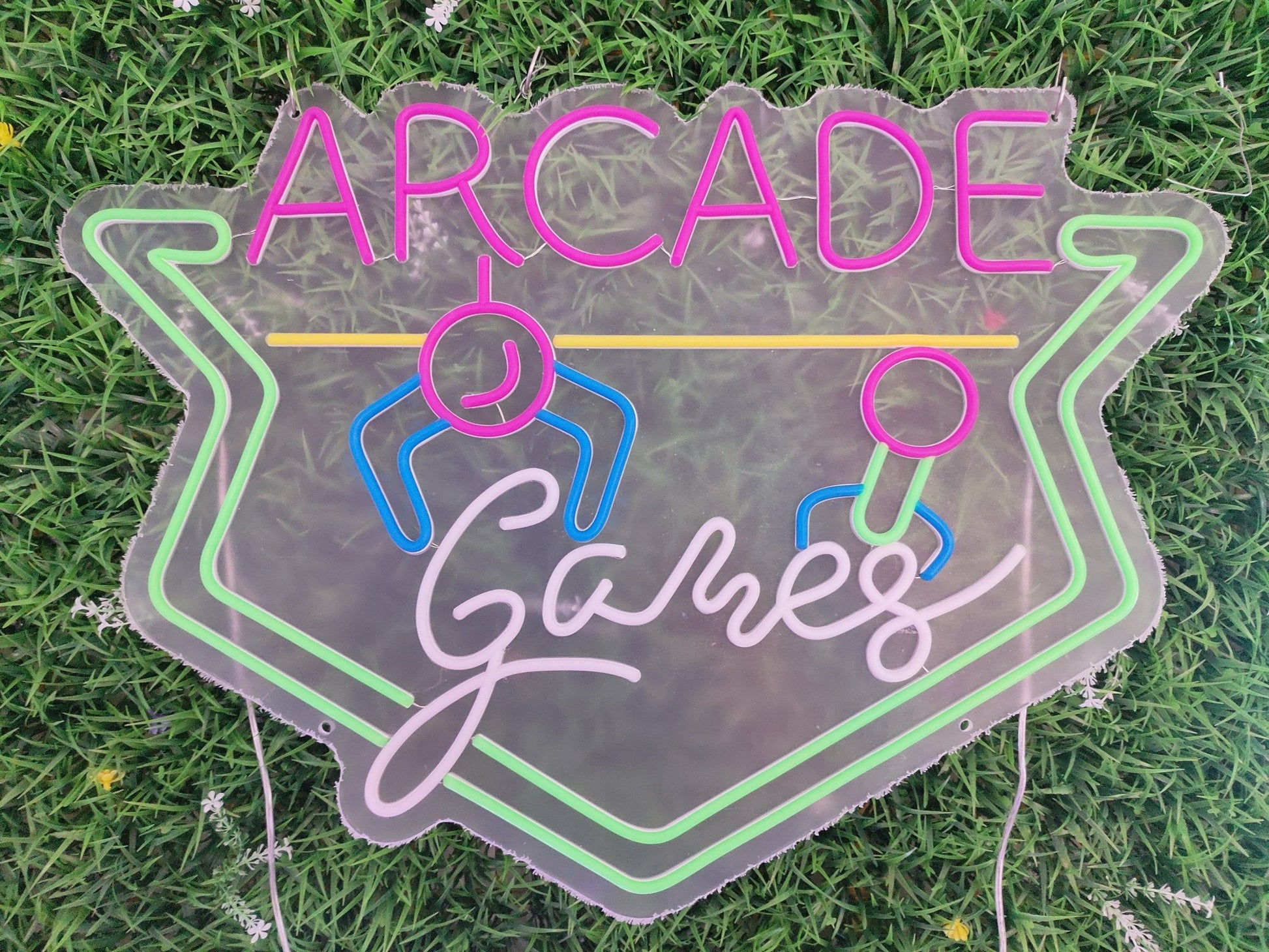 Arcade games neon sign switched off showing retro gaming design with controller figures on clear acrylic panel