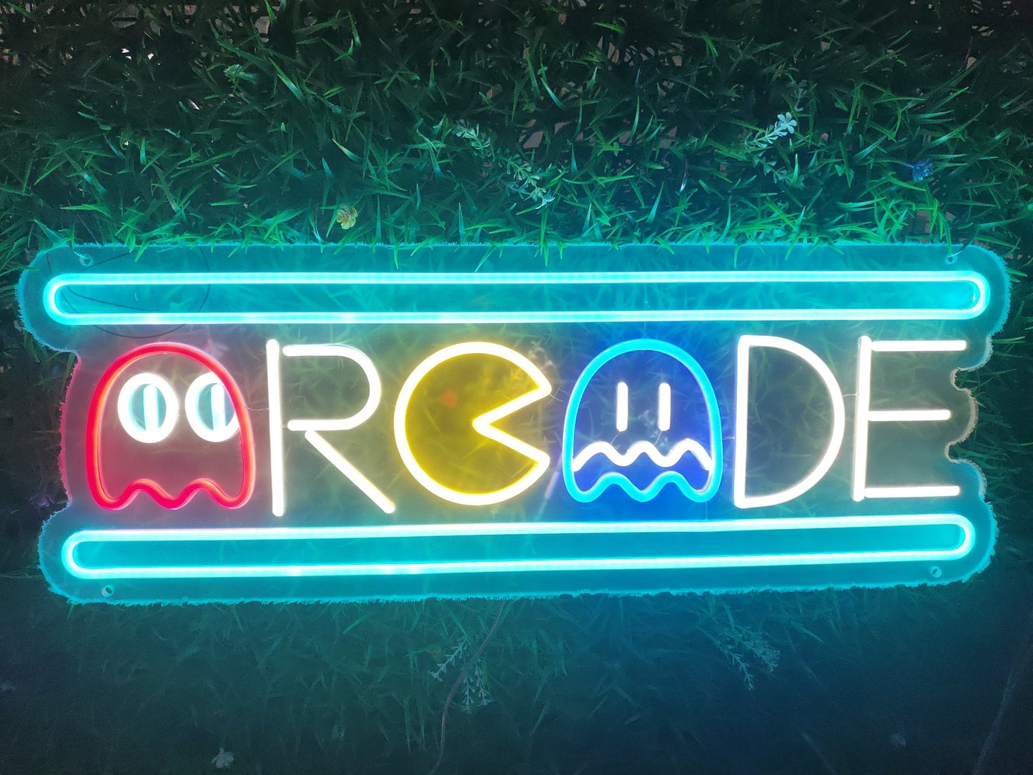 Arcade neon sign illuminated with multicolour LED showing retro gaming characters and text on clear acrylic backing