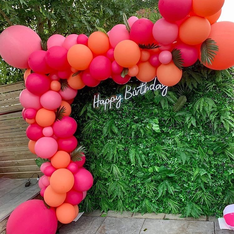White Happy Birthday FlexNeon sign mounted on a white balloon wall backdrop for a milestone birthday party.