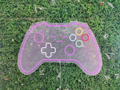 Gamepad gaming controller neon sign switched off showing modern console controller design on purple pink acrylic panel