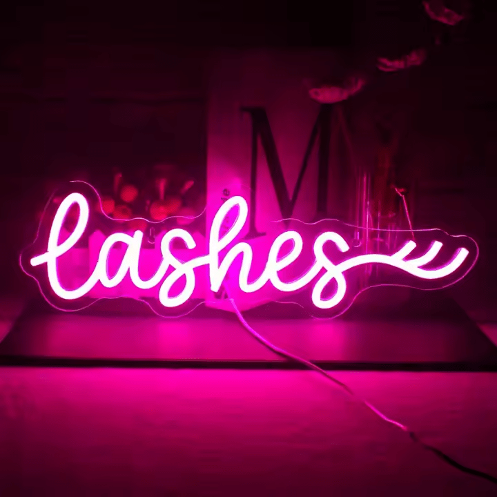 Lashes neon sign in pink LED flex with acrylic backing – cursive lettering with lash detail glowing in a beauty studio setting