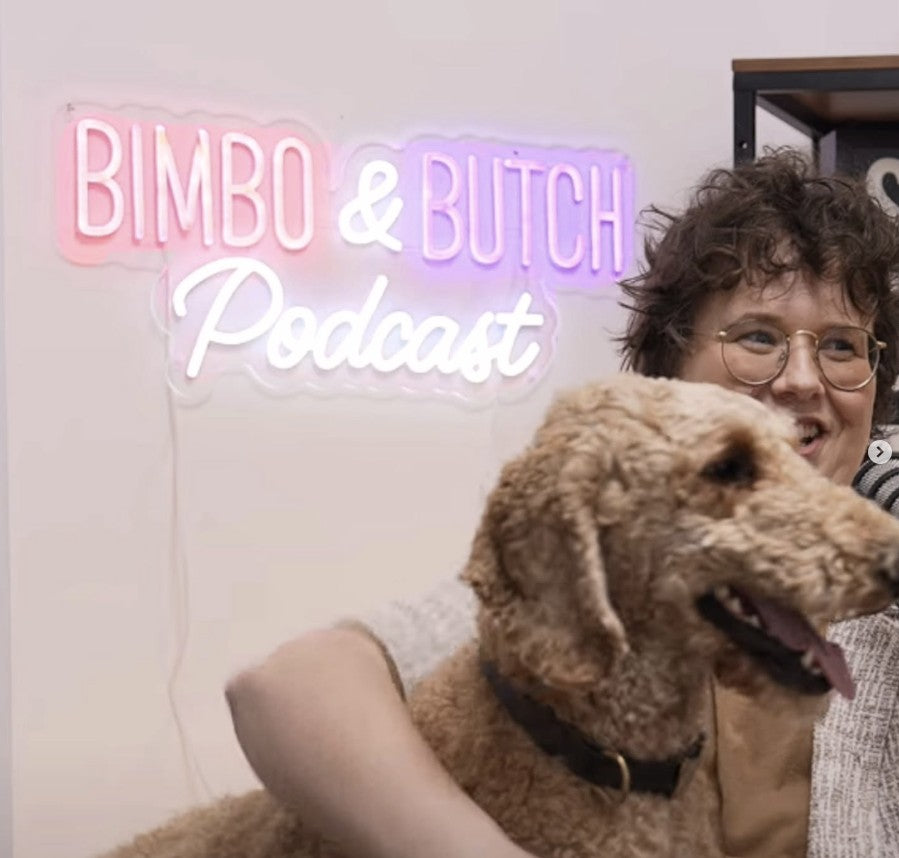 Pink and purple RGB LED neon sign for Bimbo & Butch Podcast in script font with host and dog, custom podcast branding UK