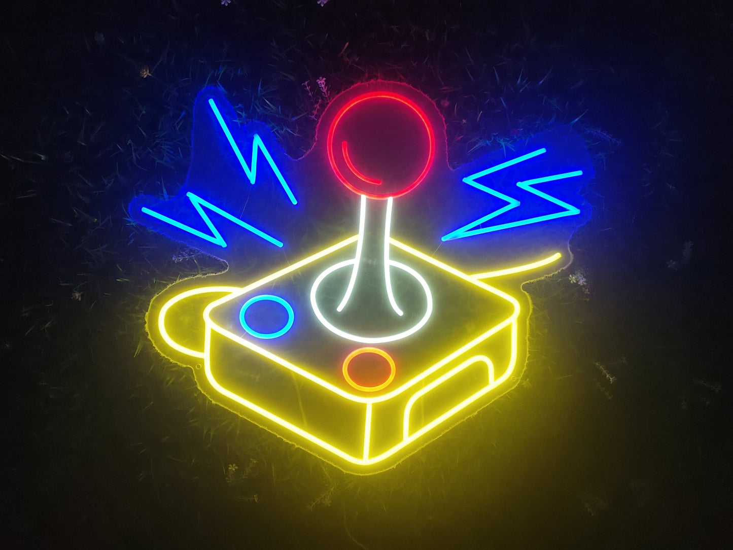 Retro joystick neon sign illuminated with multicolour LED showing arcade gaming controller design on clear acrylic backing