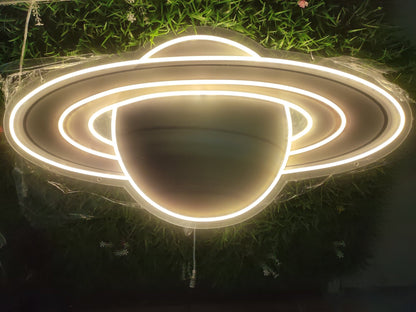 Saturn UV neon sign illuminated with warm white LED showing planet rings on clear acrylic backing